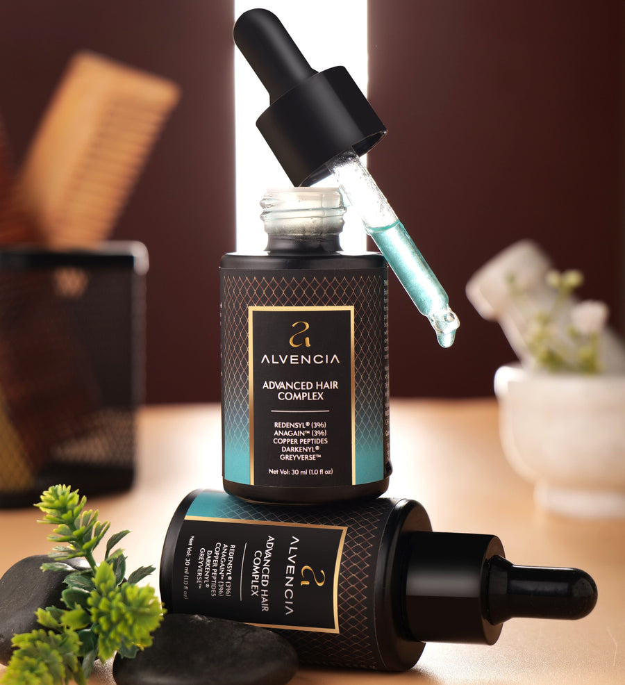 Alvencia Hair Revival Serum bottles with dropper and blue serum