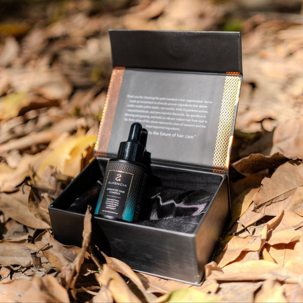 Open Alvencia box with serum bottle on autumn leaves